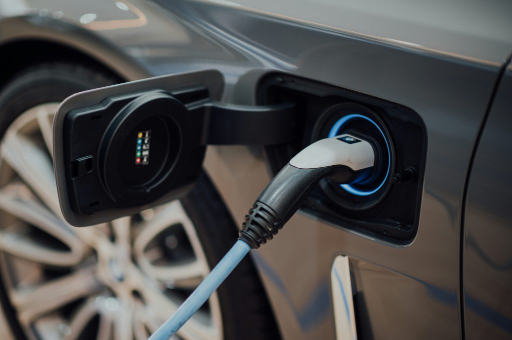 An electric car being charged at an EV charge point.